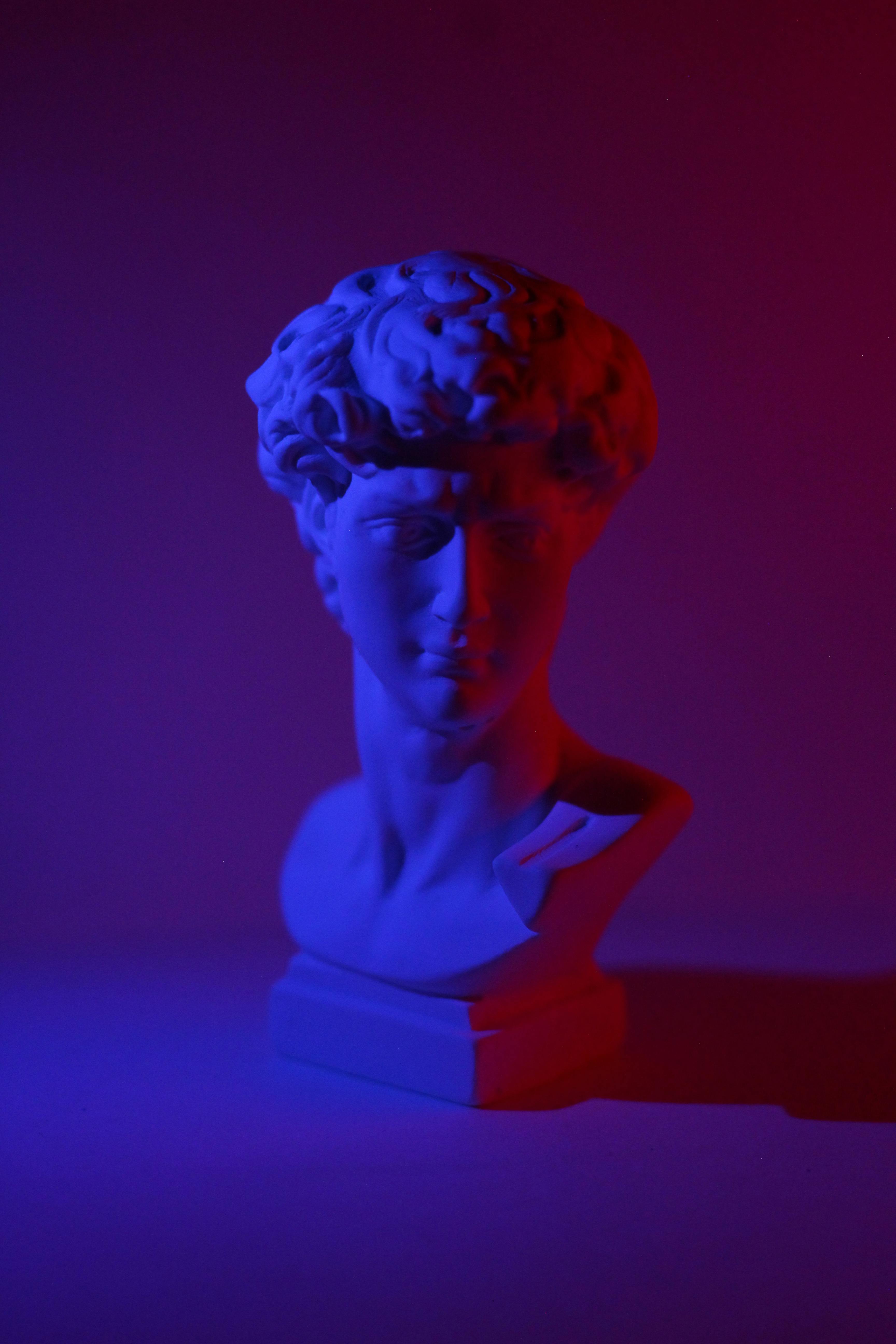 greek statue head in purple lighting